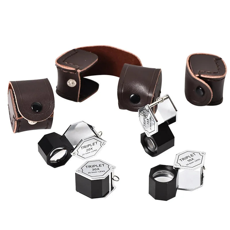 Handheld metal portable magnifying glass for jewellery and coin identification with optical glass lenses.