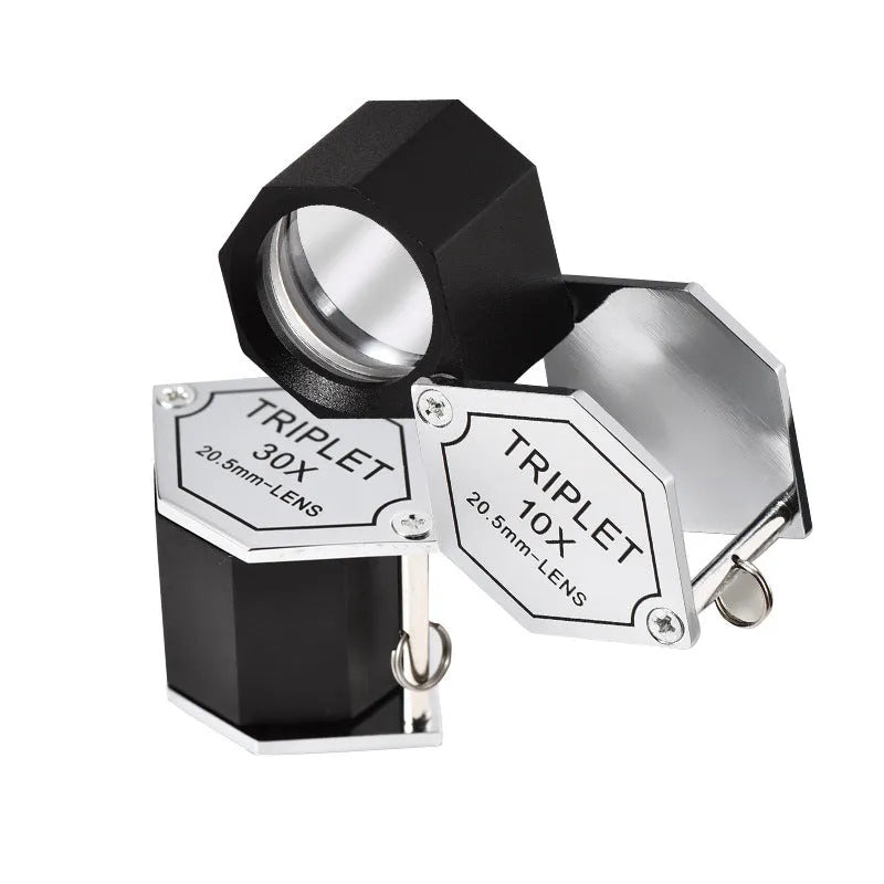 Handheld metal portable magnifying glass for jewellery and coin identification with optical glass lenses.