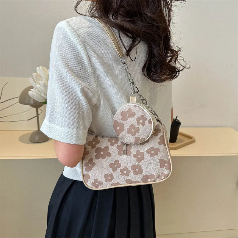 Small square PU leather shoulder bag in beige with detachable small bag on white background