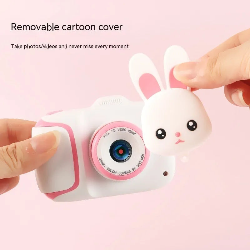 HD children's camera with 2.0 inch LCD screen in pink, showing video mode, with data cable and manual