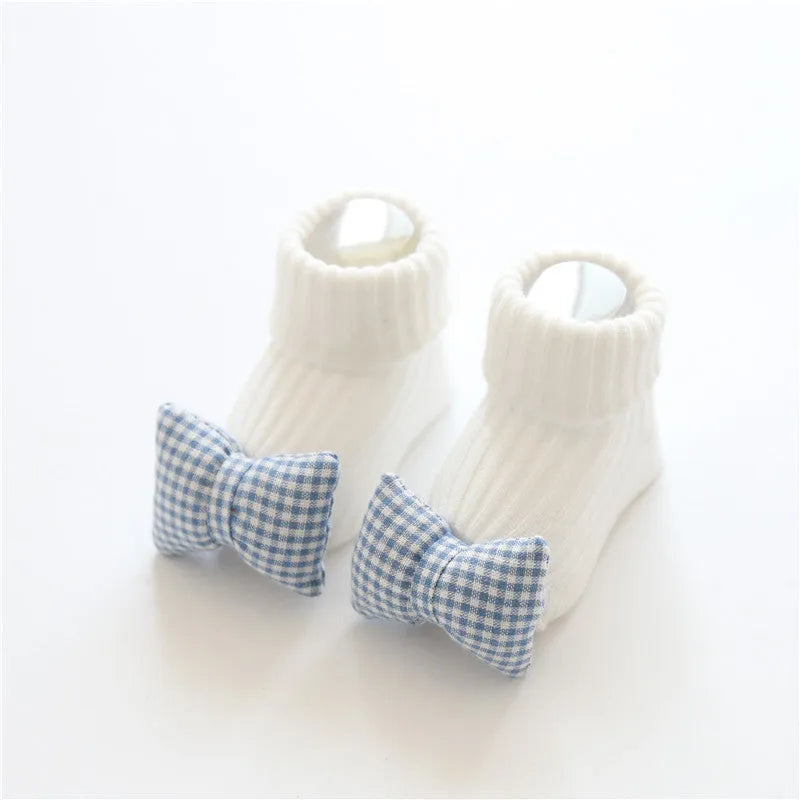 Cotton baby socks with non-slip soles in multiple designs including bows, stars, and animal prints.