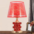 Crystal glass bedside lamp with chrome metal base, gold colour option, on a wooden bedside table