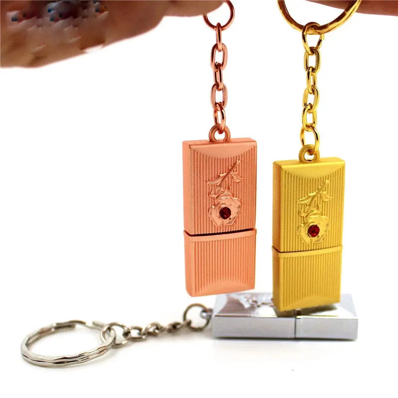 Metal and crystal USB flash drive in gold finish with decorative crystal front on white background