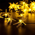 Outdoor solar-powered dragonfly string lights with 20 warm white LEDs on a 5 metre cable and IP65 waterproof rating