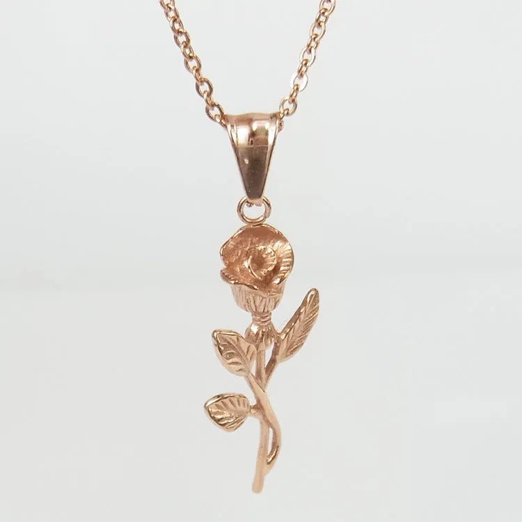 Polished stainless steel men's necklace with cross and rose pendant, gold colour, on display