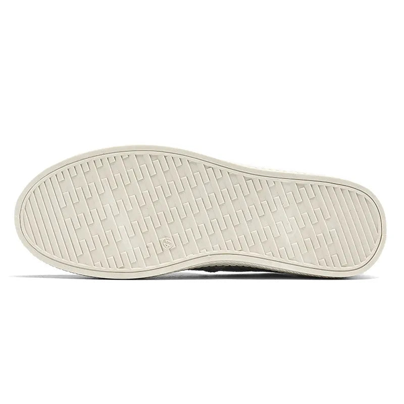 Men's beige canvas slip-on loafers with a round toe and shallow cut on a plain background.