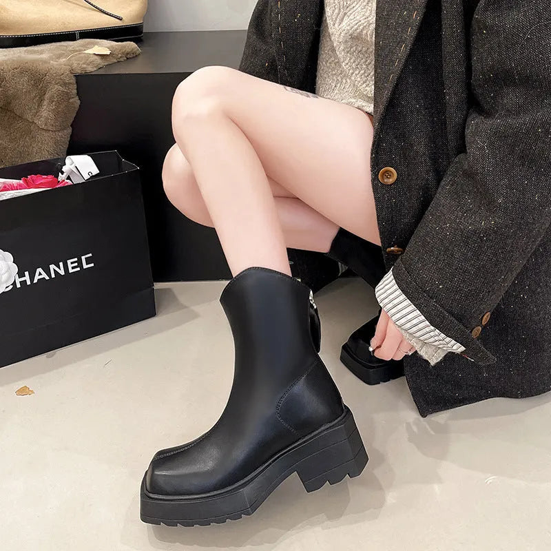 Black platform Martin boots for women with square toe, back zipper, and a high rubber sole.