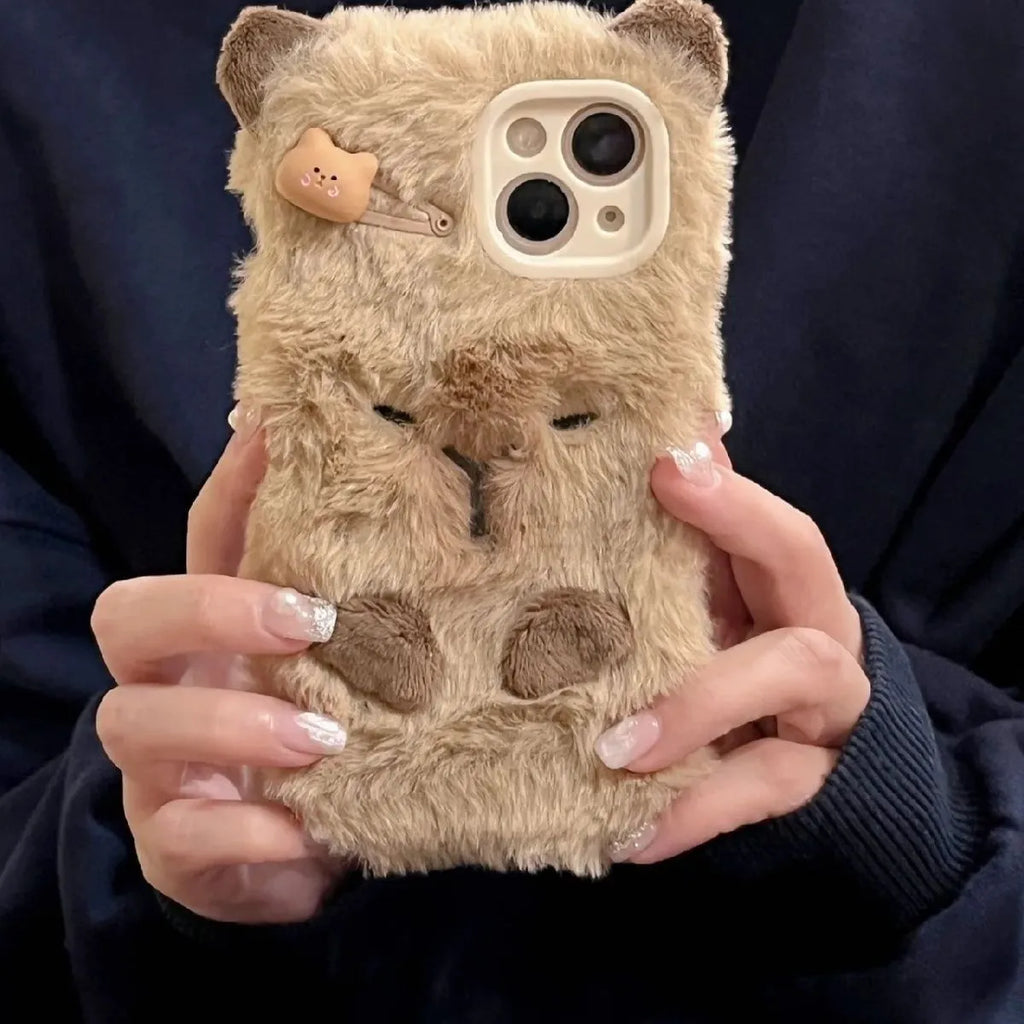 Brown furry plush capabala phone case for iPhone showing cartoon face and flannel texture