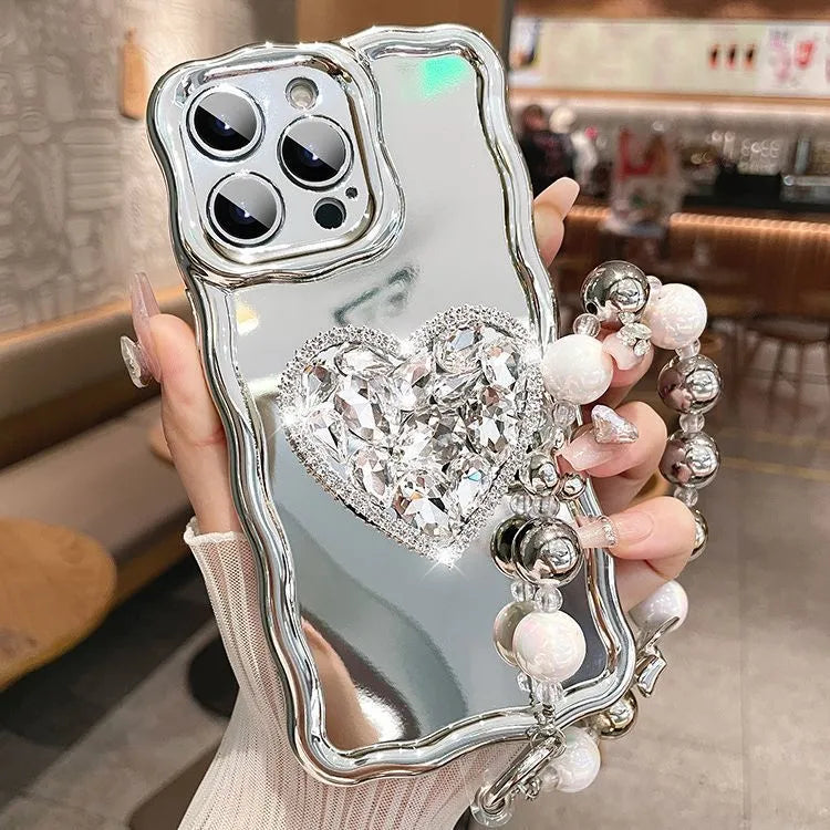 Silver grey silicone iPhone case with mirror finish, rhinestone bracket, and wrist strap lanyard.