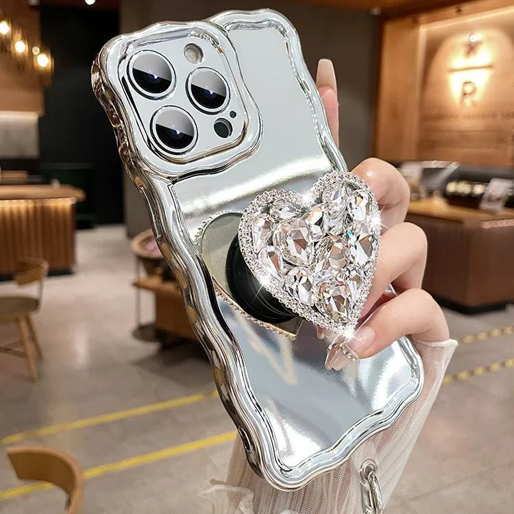 Silver grey silicone iPhone case with mirror finish, rhinestone bracket, and wrist strap lanyard.