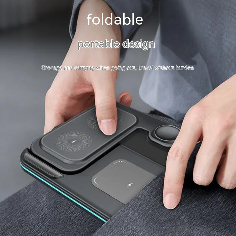 Wireless foldable fast charger in black charging a phone, headset, and watch on a desk