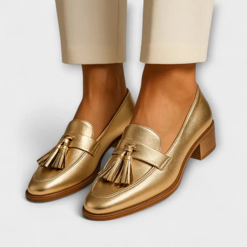 Gold PU leather low heel slip-on pumps with tassel detail and square toe on woman's feet