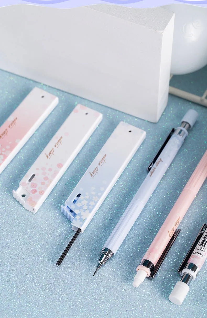 Mixed colour cartoon design automatic pencil set with three pens and boxes of HB refills.