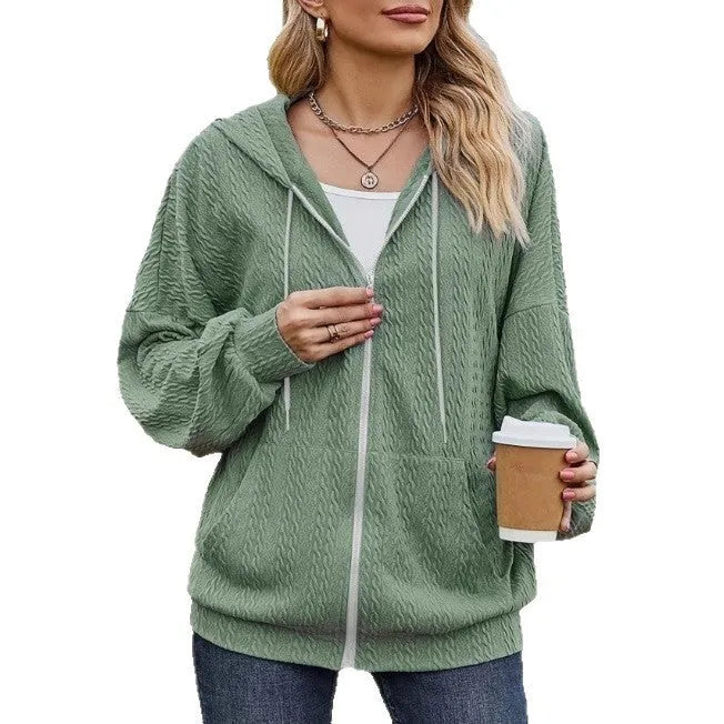 Green women's loose fit hooded zipper coat on a hanger