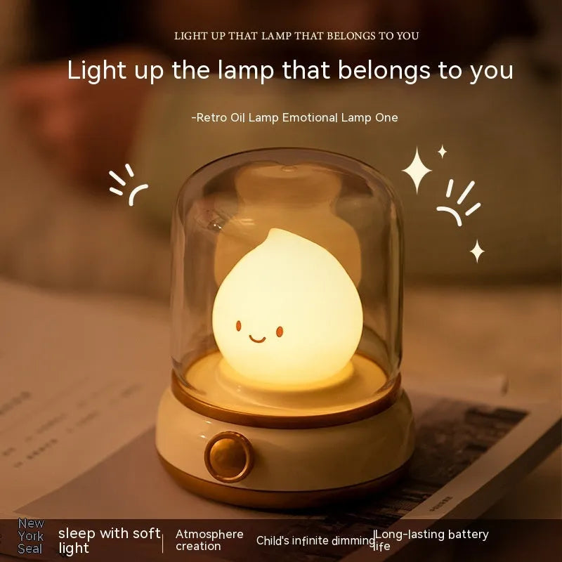 Green retro oil lamp design USB rechargeable LED desk night light on a wooden table.