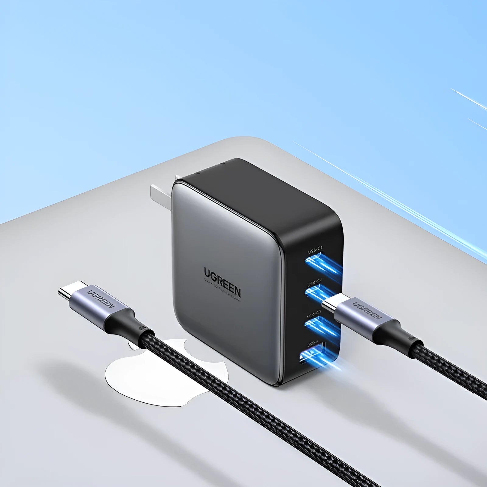 Compact white 100W Gallium Nitride fast charger plug with multiple USB-C ports on a desk.