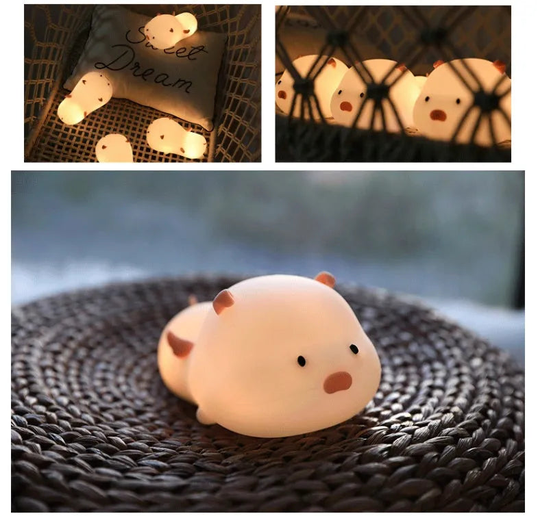 Blue silicone pig-shaped night light with USB charging port