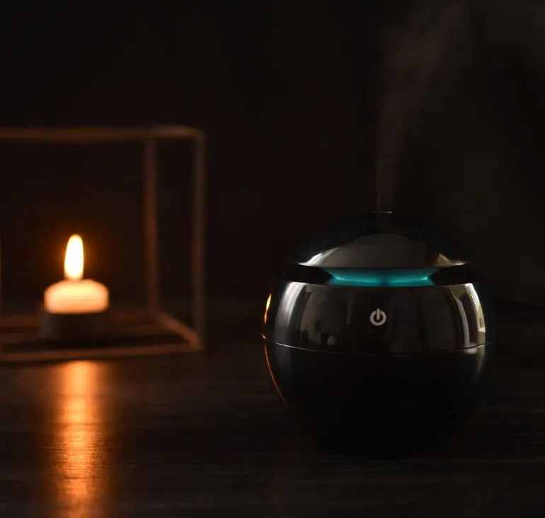 USB ultrasonic atomizer with colourful light and 130ml water tank in white colour option on a wooden desk