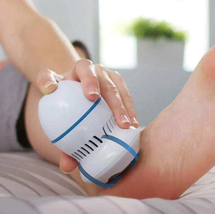 Beige and white electric foot file grinder with USB cable, two grinding heads, and cleaning brush