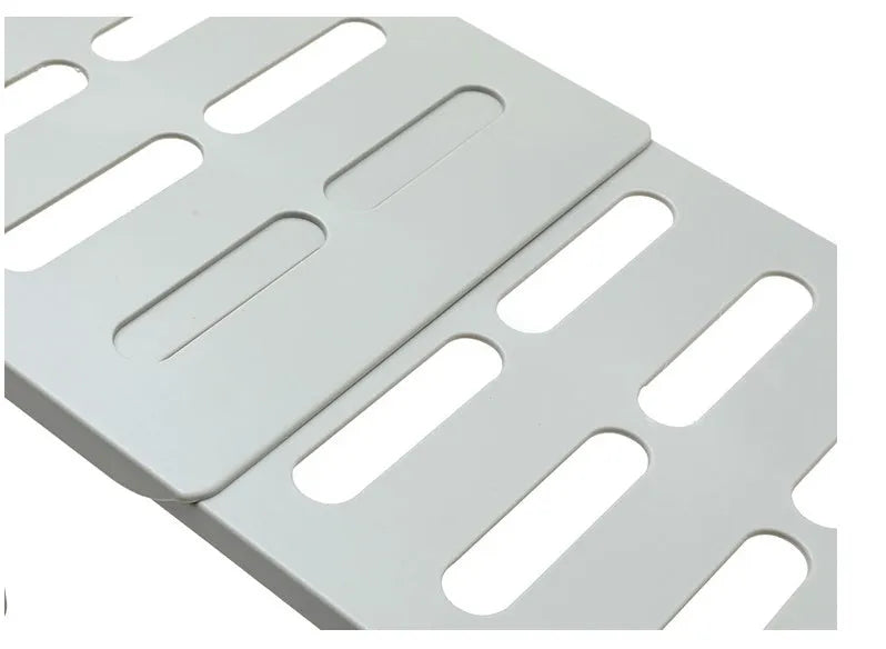 White telescopic plastic kitchen storage rack at adjustable height