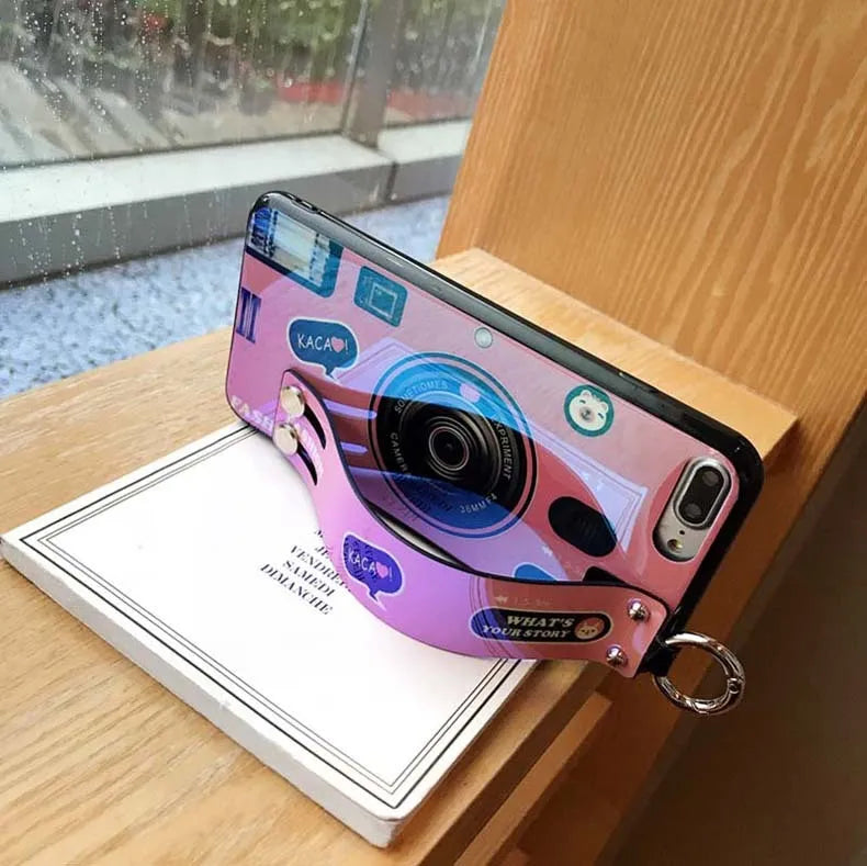TPU iPhone case with retro camera design in blue or pink, back cover style, optional wrist strap.