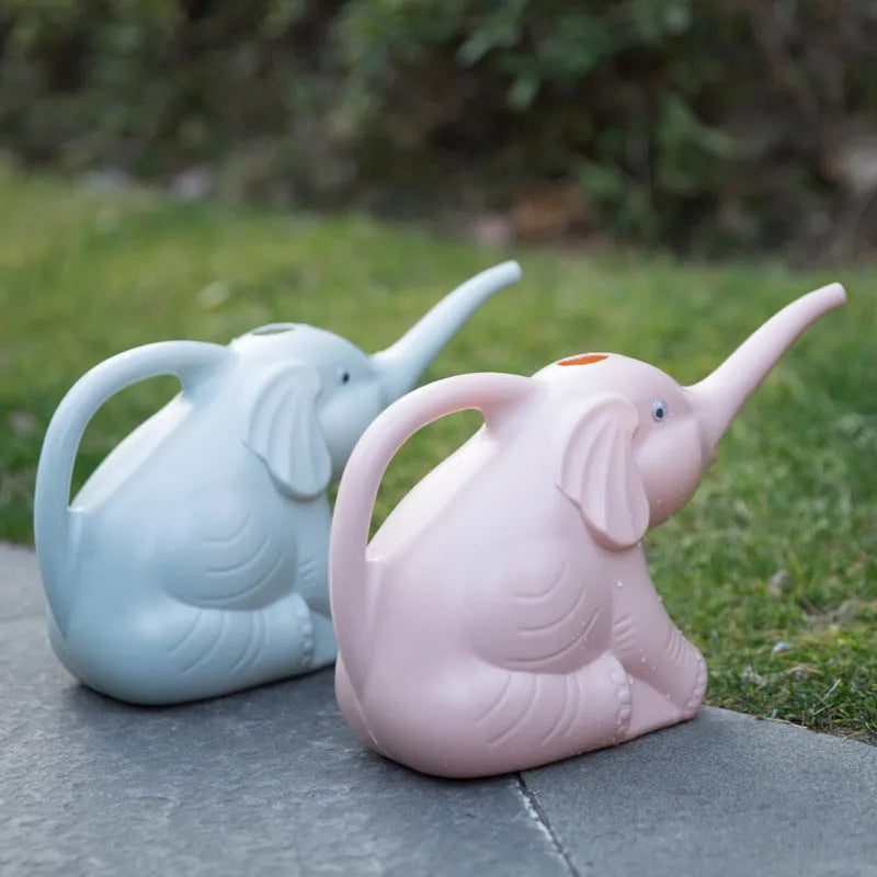 Pink children's watering can shaped like a sitting elephant with a long nozzle and bottle-shaped handle.