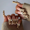 Leopard print butterfly false nail set with WM296 colour designs for press-on manicure application