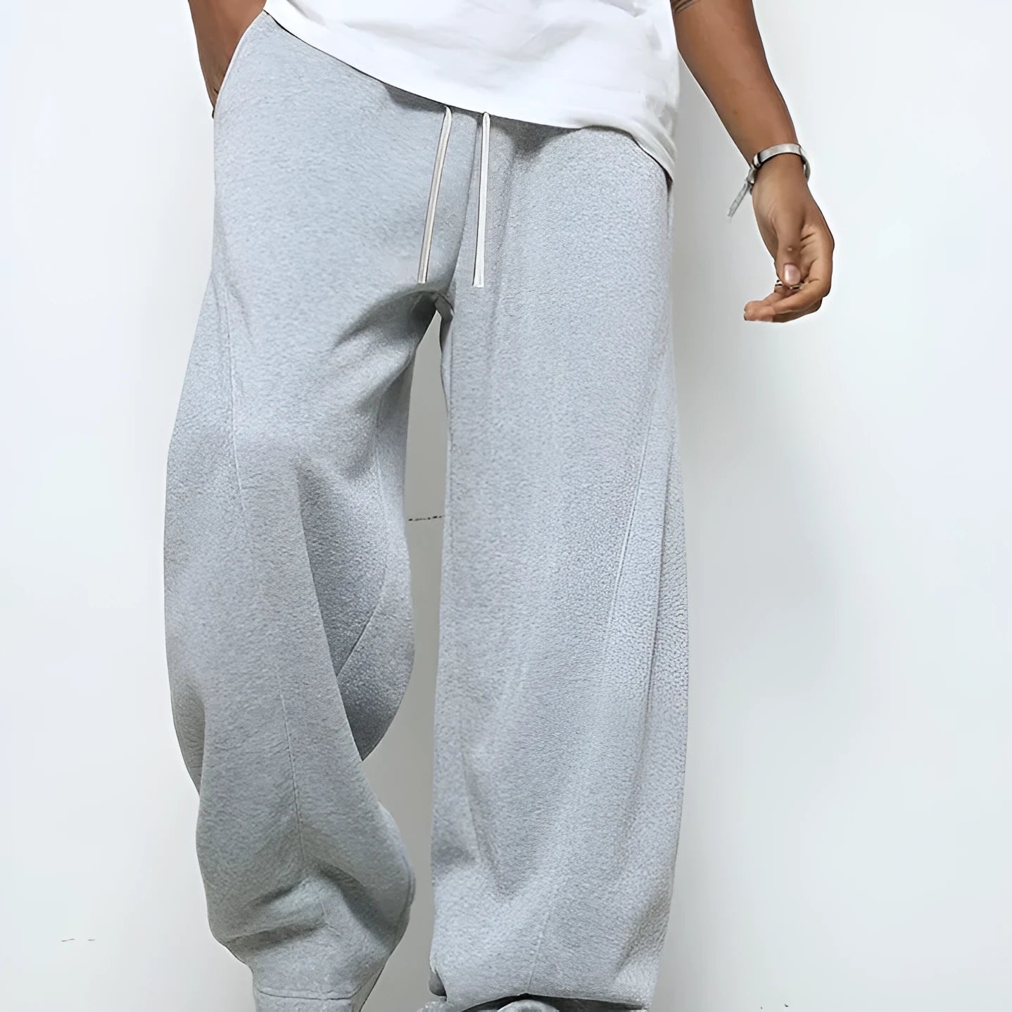 Man wearing grey micro-elastic casual trousers with a drawstring waist and straight leg.