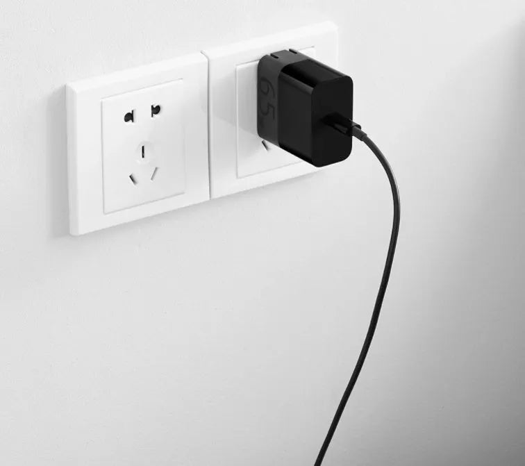 Black ZMI USB-C 65W laptop power adapter with compact design and notebook charging capability