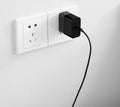 Black ZMI USB-C 65W laptop power adapter with compact design and notebook charging capability