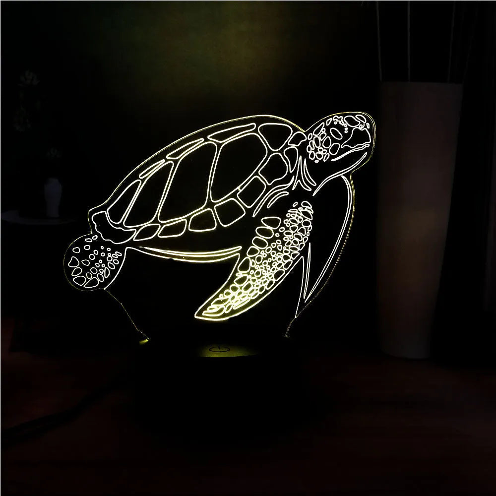 3D clear acrylic turtle-shaped LED night light with multicolour glow on a dark surface.