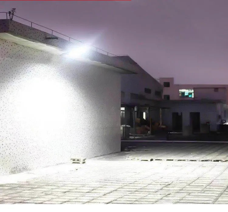 Black solar-powered outdoor security light with motion sensor on a wall