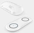 Black and white dual wireless charging pad with two phones charging simultaneously
