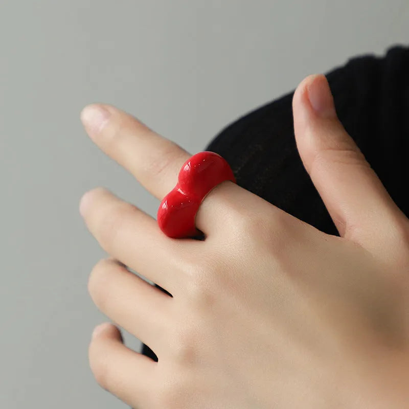 Colourful three-dimensional enamel heart ring on a zinc alloy band.