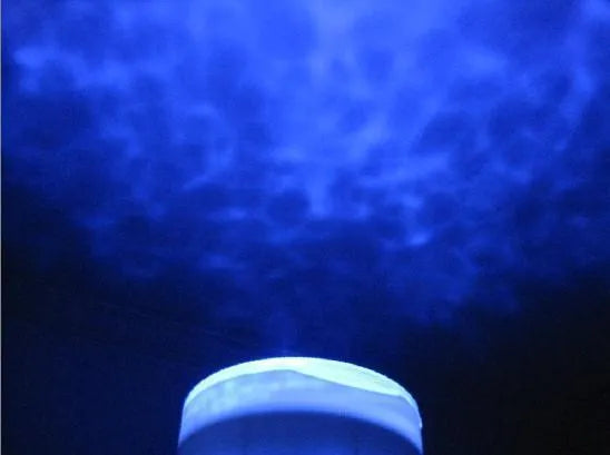 Blue coloured ocean-themed LED projection lamp on a surface for children's puzzle activities.