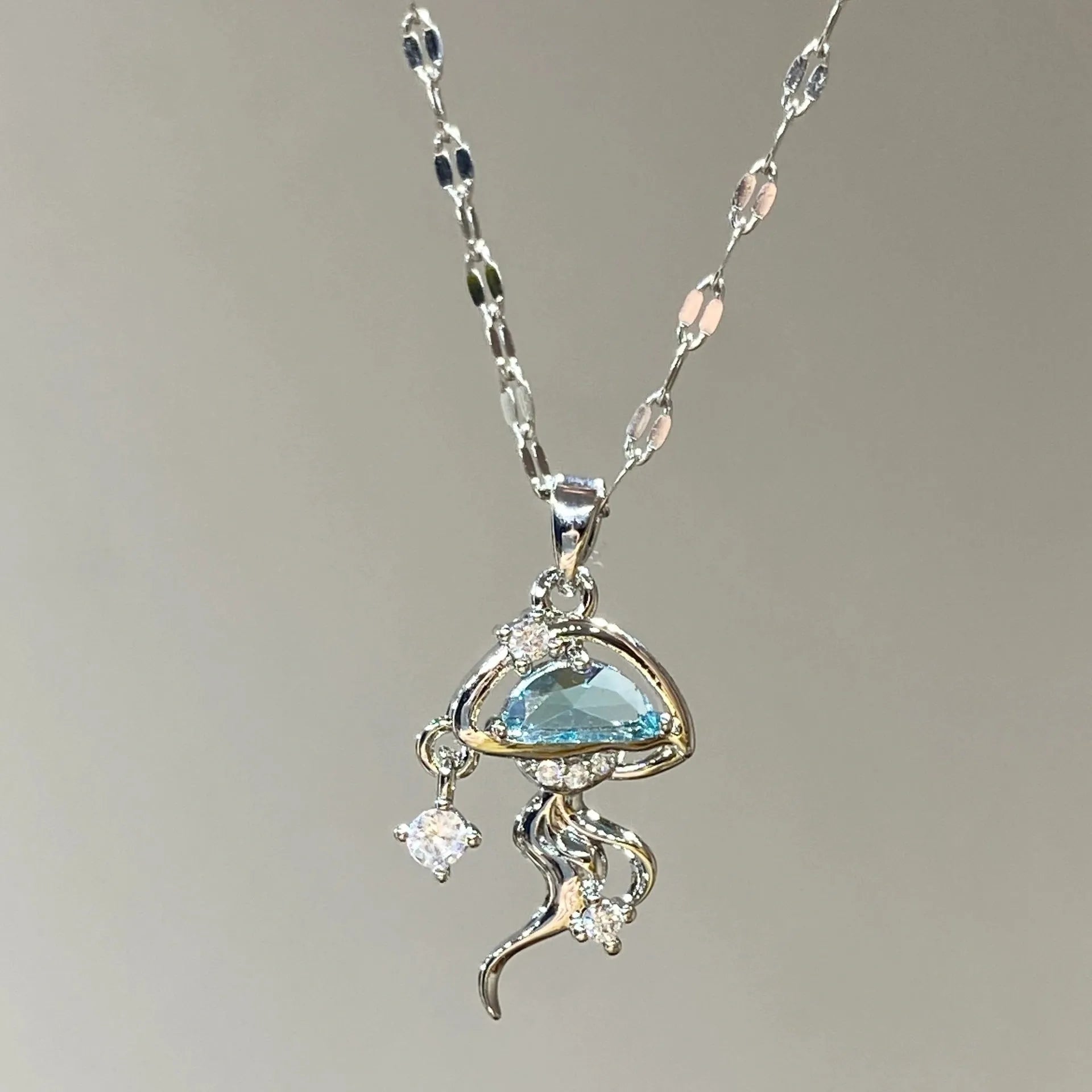Blue jellyfish pendant necklace on adjustable sterling silver chain with white gold plating