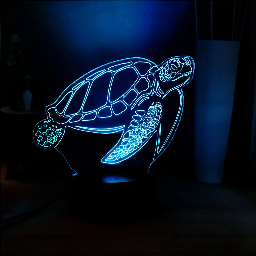 3D clear acrylic turtle-shaped LED night light with multicolour glow on a dark surface.