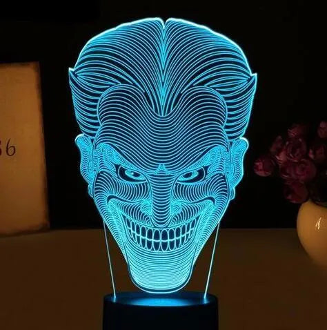 A 3D acrylic LED lamp emitting a gradient of colours, shown with its square base and remote control.