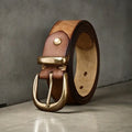 Men's casual leather belt in black with a copper pin buckle on a jeans background