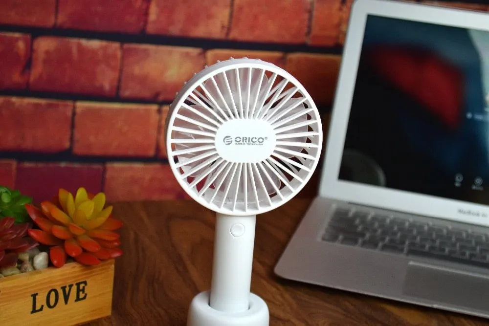 White ORICO FH1 portable USB rechargeable desk fan on a table