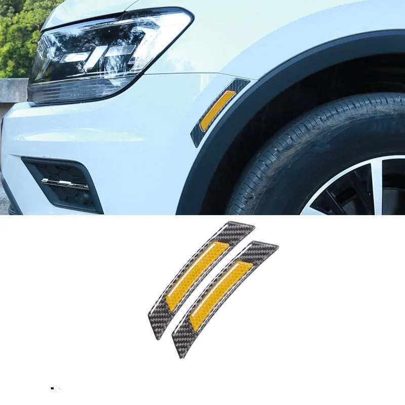 Set of four fluorescent reflective car wheel brow adhesive strips in blue, red, white, and yellow on a black car wheel arch