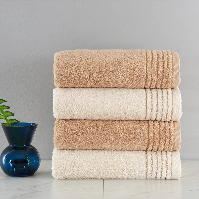 Cotton towel set showing bath, hand and face towels in beige or brown colours