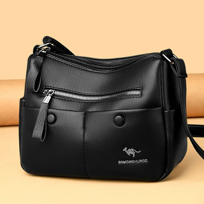 Soft square black PU leather women's crossbody shoulder bag showing front view and open interior with multiple pockets.