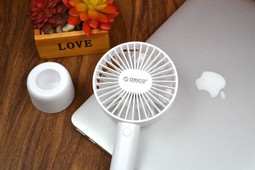 White ORICO FH1 portable USB rechargeable desk fan on a table