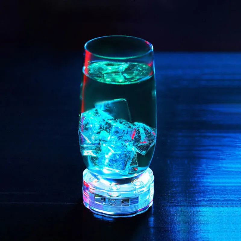IP68 waterproof LED remote control diving light with 16 colour modes placed in a glass vase of water