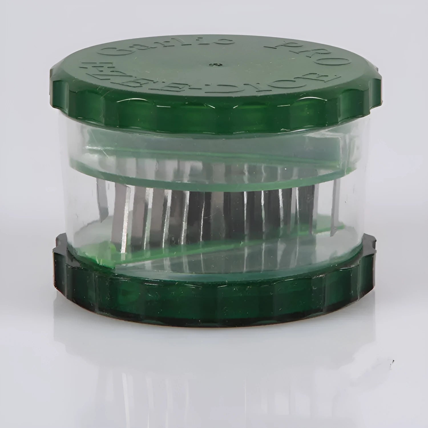 Green transparent silicone garlic peeler tube on a kitchen counter