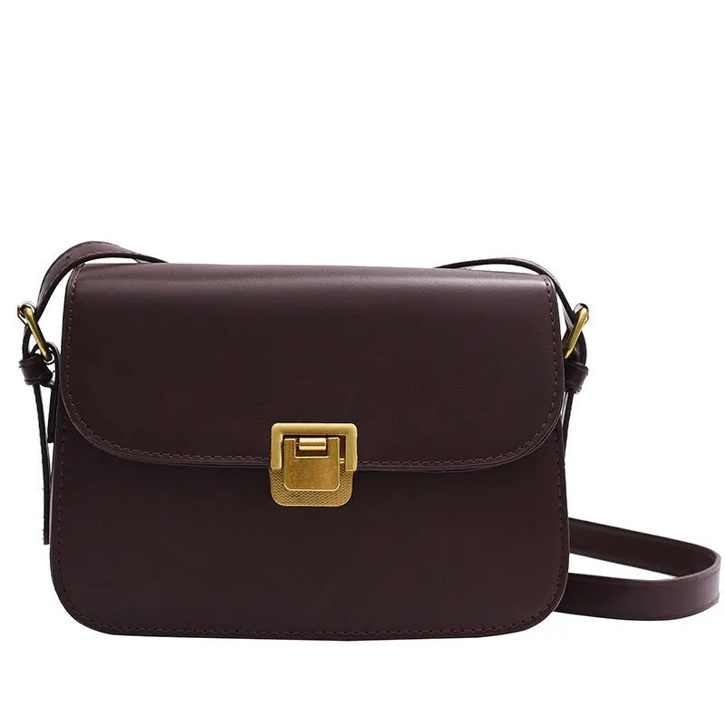 Soft black PU leather women's square cross-body bag with textured finish shown on model.