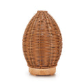 Hollow rattan aroma diffuser with light wood grain base showing 100ml capacity ultrasonic unit