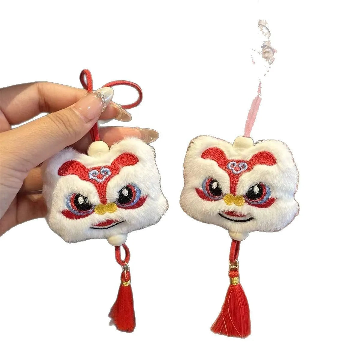 Handmade Chinese lion plush ornament with star stone details on blue and yellow keychain