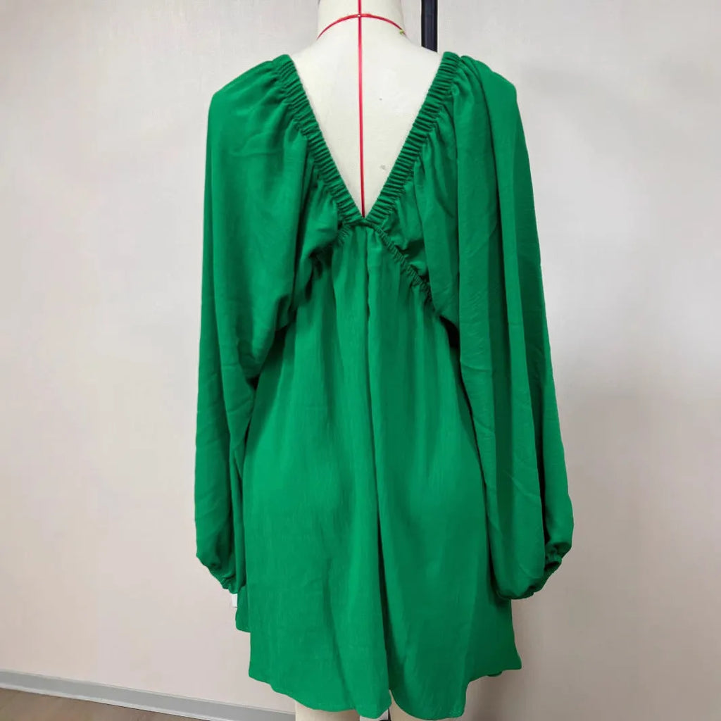 Women's apricot V-neck dress with puff sleeves and a flounced swing skirt, also available in green, black, and white.